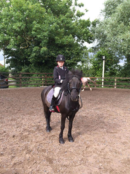 Standing to attention for the horse riding lesson